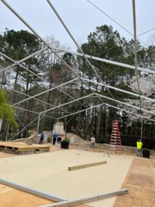 A frame tent set up for a corporate event, featuring ample space and professional styling for business gatherings and conferences.