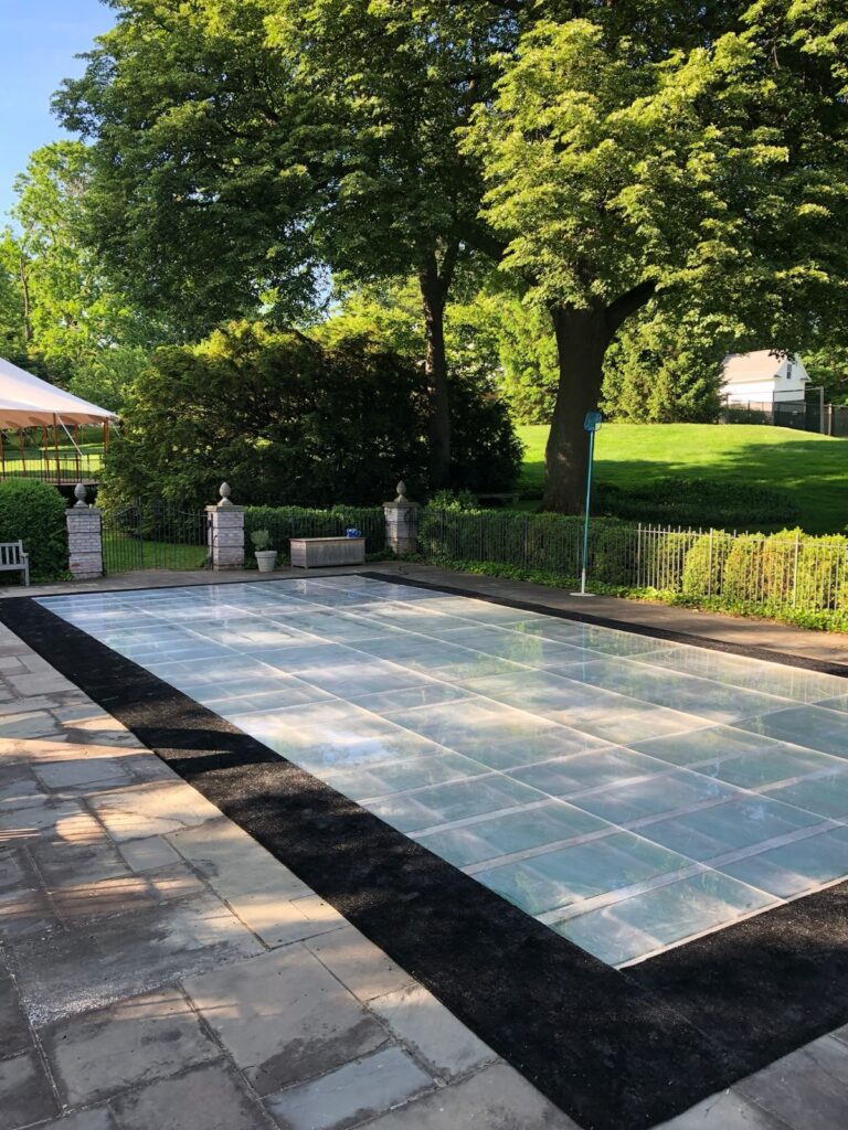 Event space with a beautiful pool cover installation, offering a unique space for guests to enjoy a celebration or gathering.