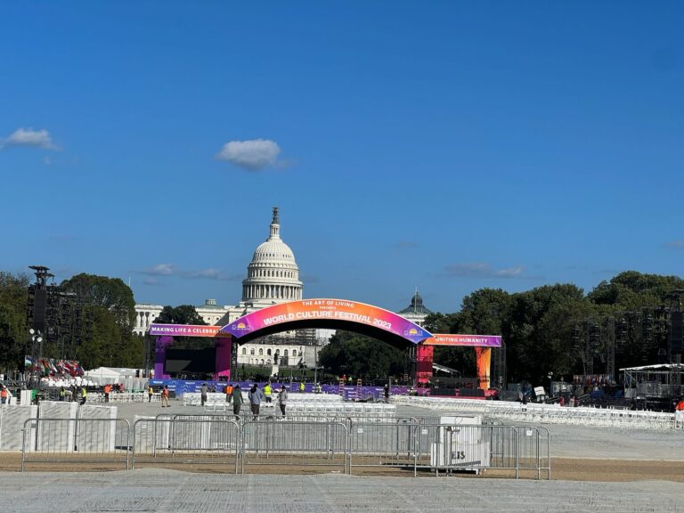 Crowd control barriers arranged in front of a large festival stage near the Capitol for public safety and event organization.
