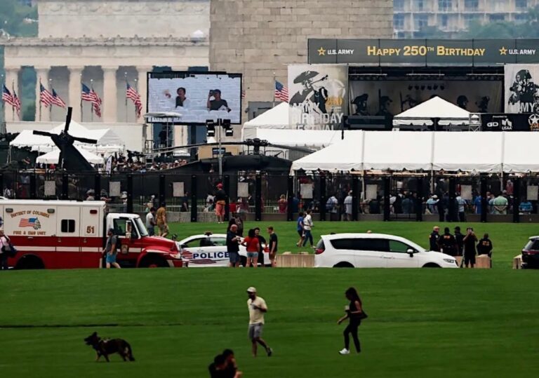Multiple white frame tents set up for an outdoor event, featuring green turf protection and LED lighting for a lively ambiance.