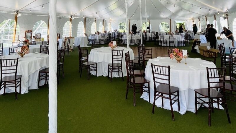 Rent tablecloths for elegant event setups in spacious outdoor tents, perfect for weddings and celebrations.