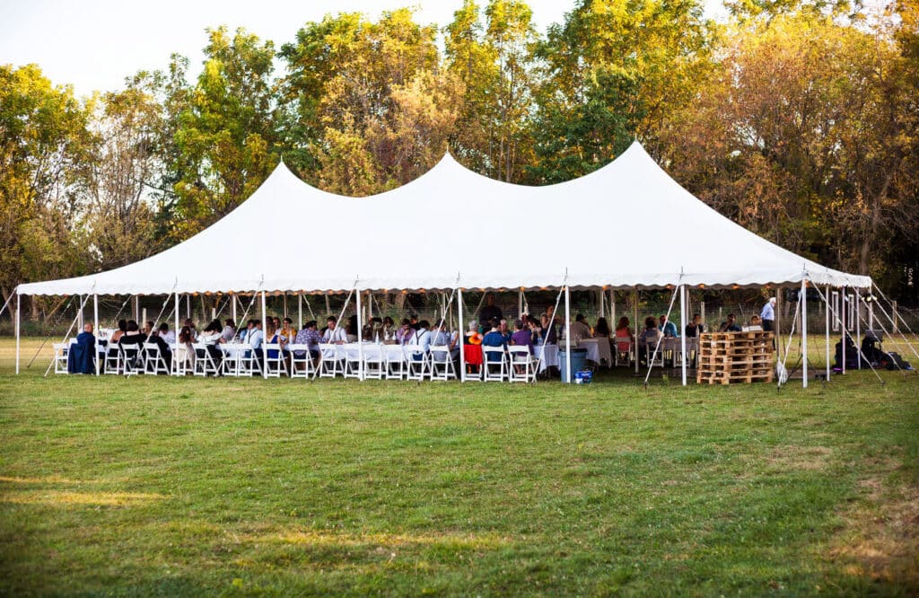 Outdoor tent rental set up for a large event, offering shelter and comfort for guests.
