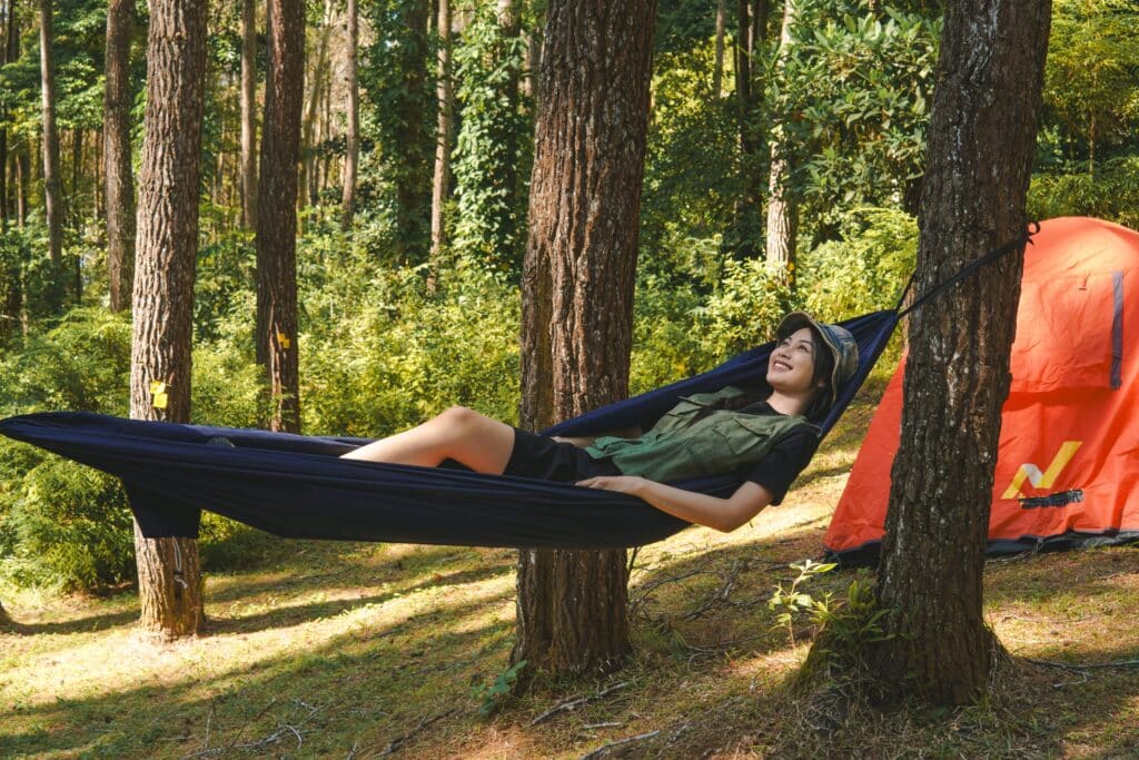 Hammock tent set up in the woods for a relaxing outdoor camping experience.
