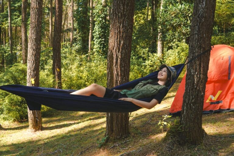 Hammock tent set up in the woods for a relaxing outdoor camping experience.